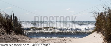 Panaromic View Looking Through The Sand Dunes Of Large Ocean Waves Crashing On The Beach On Fire Isl