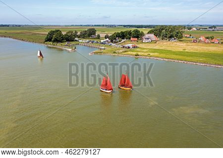 Aerial From Traditional Dutch Wooden Boats At The Ijsselmeer Near The Harbor From Laaxum In Frieslan