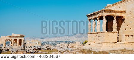 a panoramic view of the Acropolis of Athens, Greece, highlighting the famous Porch of the Maidens, from the Erechtheion or Temple of Athena Polias, on the right