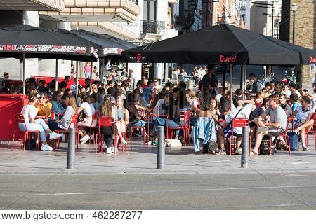 Ixelles, Brussels - Belgium - 10 09 2018 - Young People Having A Drink On A Sunny Terrace On A Late 