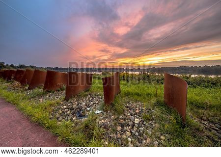 Rusty Metal Curved Objects In Landscape With Lake And Sunset At Piccardthofplas Groningen City, Neth