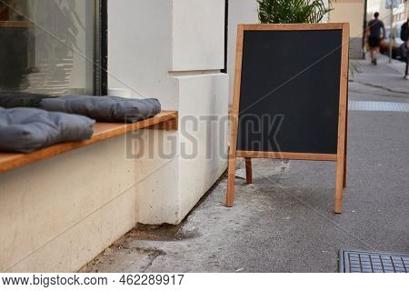 Empty menuboard on in front of a restaurant, blank chalkboard, no text