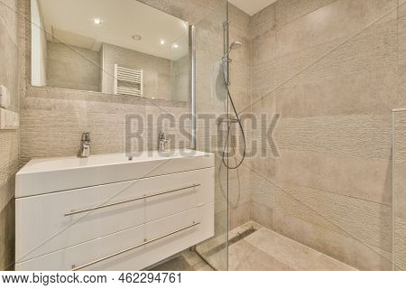 Glass Partition Between Shower Tap And Wall Hung Toilet In Modern Restroom At Home