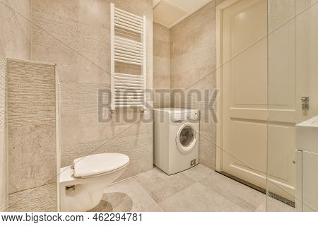 Glass Partition Between Shower Tap And Wall Hung Toilet In Modern Restroom At Home