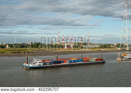 Antwerpen, Flanders, Belgium - July 10, 2022: Industry Along Scheldt River. Loaded Container Barge I