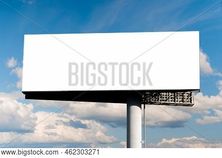 Mock Up - Blank Wide Horizontal White Billboard Or Large Advertising Display Against Blue Sky With W