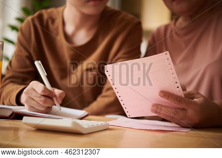 Closeup Image Of Grandmother And Grandson Checking Biils And Paychecks