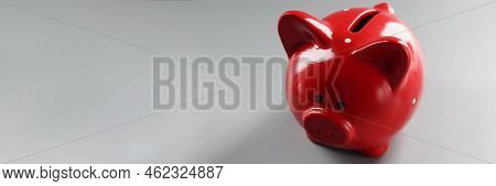 Close-up Of Bright Red Piggybank Container On Grey Surface, Empty Thing To Put Money. Hole In Cerami