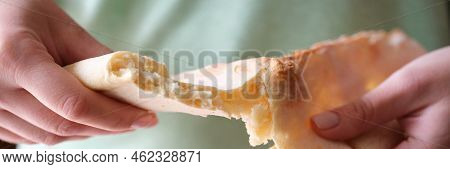 Flour Bun Flatbread In Hands Break Apart. Female Arm Breaking Freshly Baked Bread