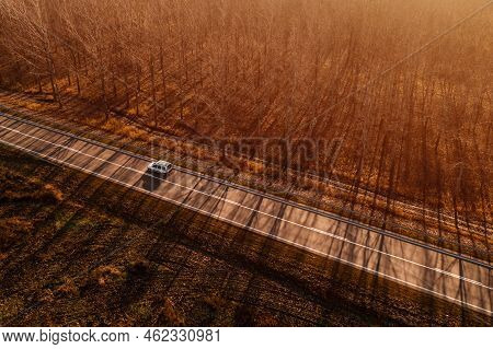 Aerial View Of Multi-purpose (mpv) Or Leisure Activity (lav) Vehicle Mpv On Road Through Autumn Scen