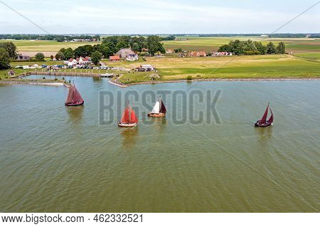 Aerial From Traditional Dutch Wooden Boats At The Ijsselmeer Near The Harbor From Laaxum In Frieslan