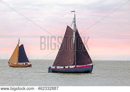 Traditional Dutch Wooden Boats At The Ijsselmeer In Friesland The Netherlands At Sunset