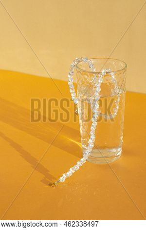 Costume Jewelry On A Monochromatic Background In The Interior