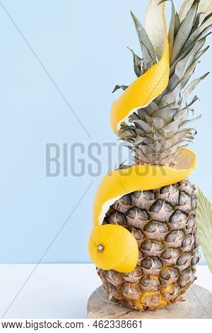 Pineapple In Orange Peel On A Monochromatic Background