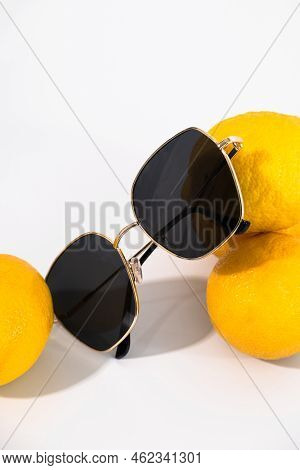 Glasses Lying On Yellow Juicy Lemons. High Quality Photo