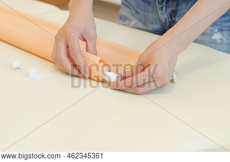 Assembly Of Roller Blinds. Woman's Hands Assembling Roller Blinds, Close-up