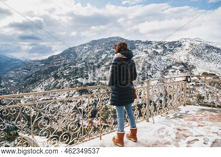 Back View Of Young Woman Standing At Mountain Top Observation Deck Over Vouraikos Gorge. Mega Spileo