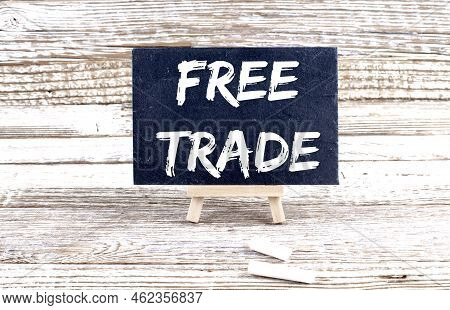 Free Trade Text On Miniature Chalkboard On Wooden Background