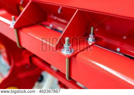 Lock Nut. Using A Second Nut To Prevent Unscrewing. Lock Nut. A Fragment Of A Red Agricultural Machi