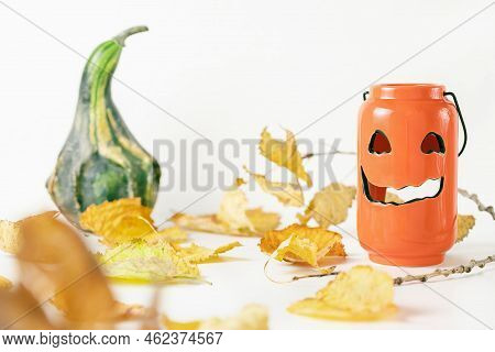 One Small Green Decorative Pumpkin, Leaves And Scary Pumpkin Candle Holder On White Background. Fall
