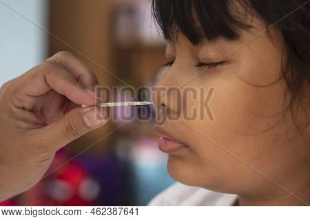 Asian Girl Getting Nasal Swab Rapid Self-testing Antigen Kits (atk) Coronavirus Disease (covid-19) T