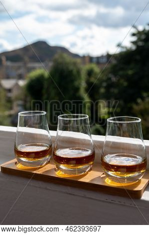 Flight Of Single Malt Scotch Whisky Served On Old Window Sill In Scottisch House With View On Old Pa