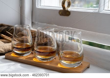 Flight Of Single Malt Scotch Whisky Served On Old Wooden Window Sill In Scottisch House In Edinburgh