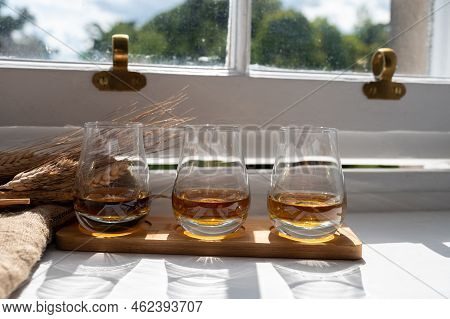 Flight Of Single Malt Scotch Whisky Served On Old Wooden Window Sill In Scottisch House In Edinburgh