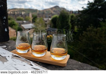 Flight Of Single Malt Scotch Whisky Served On Old Window Sill In Scottisch House With View On Old Pa