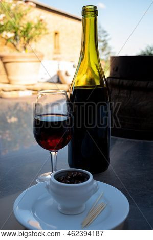 Tasting Of Red Wine By Old Wine Maker In Pierres Dorées Region With Yellow Stone Houses On South Of