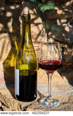 Tasting Of Red Wine By Old Wine Maker In Pierres Dorées Region With Yellow Stone Houses On South Of