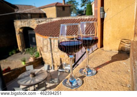 Tasting Of Red Wine By Old Wine Maker In Pierres Dorées Region With Yellow Stone Houses On South Of