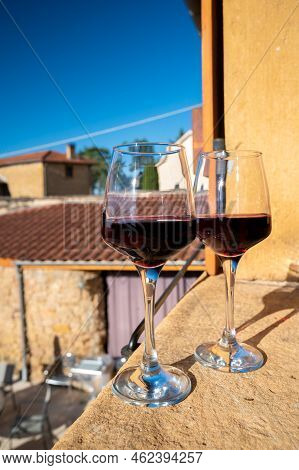 Tasting Of Red Wine By Old Wine Maker In Pierres Dorées Region With Yellow Stone Houses On South Of