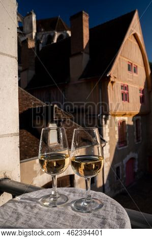 Tasting Of White Grand Cru Classe Chablis Wine With Old French Houses On Background, Burgundy, Franc