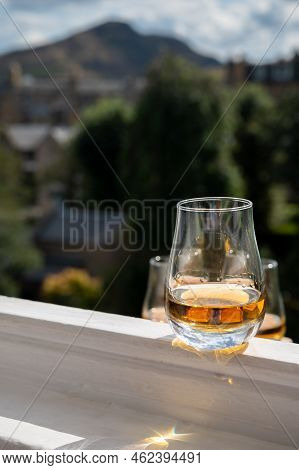 Glass Of Single Malt Scotch Whisky Served On Old White Window Sill In Scottisch House With View On O