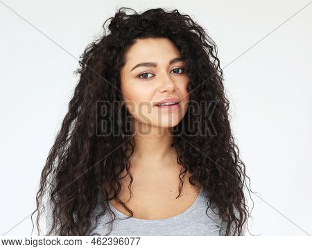 Young Smiling Mulatto Woman With Long Curly Haor Wearing Casual Shirt, Feel Happy And Smiling