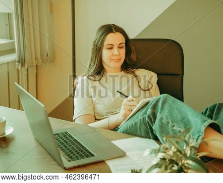 Woman On Remote Work Or Online Education, Using Tablet Computer, Papers And Notes, Indoors At Office
