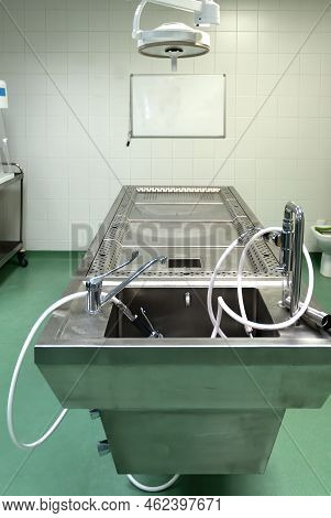 A Stainless Steel Operating Table Used To Perform Dissection Work In An Autopsy