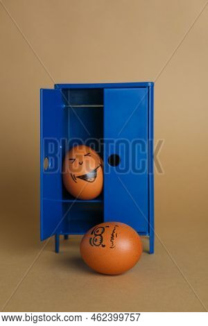 Happy Egg Hiding In Closet And Playing Prank On Another One Against Brown Background
