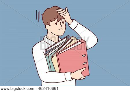 Stressed Businessman Holding Folders Feel Overworked In Office. Unhappy Tired Male Employee Overwhel
