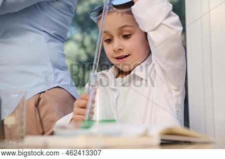 Smart Caucasian Preschool Little Girl Wearing White Lab Coat, Learning Chemistry In The School Scien