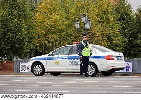 Moscow, Russia - September 2022: Traffic Police Officer Standing On The Road Near Official Car. Poli