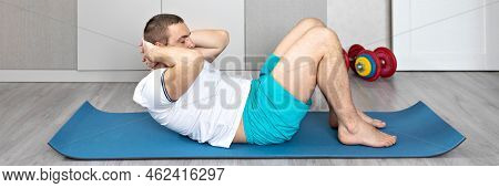 A Strong, Healthy Man With Muscles, Training At Home In The Plank Position. Fitness At Home. Banner.