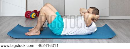 A Strong, Healthy Man With Muscles, Training At Home In The Plank Position. Fitness At Home. Banner