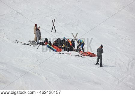 Les Sybelles, France - Circa 2022: Rescuers helping skier after accident tending to injuries