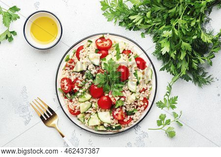 Bulgur Tabbouleh Salad With Fresh Tomatoes, Cucumbers And Parsley. Traditional Middle Eastern And Ar