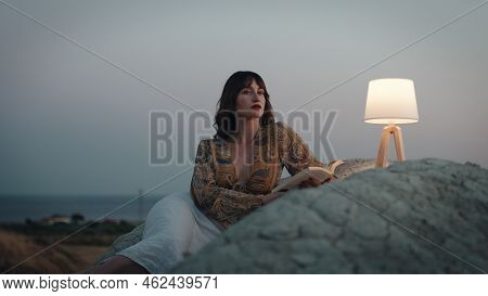 Beautiful Girl Enjoy The Sunset On The Mountain In The Evening With Abat Jour Lamp On The Stones