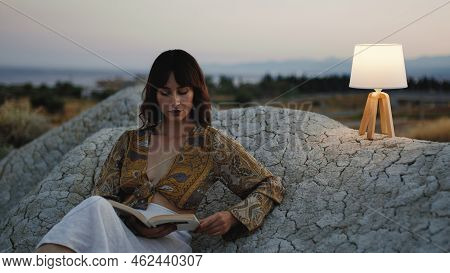 Beautiful Girl Enjoy The Sunset On The Mountain In The Evening With Abat Jour Lamp On The Stones