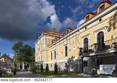 Estonia, Viljandi, September, 2022: Beautiful Yellow Renovation House Under Red Tiles With Glass Ver