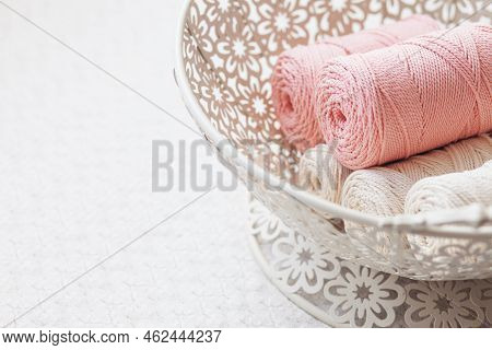 Handmade Macrame Braiding And Cotton Threads In White Basket. Cotton Macrame Cords And Ropes Against